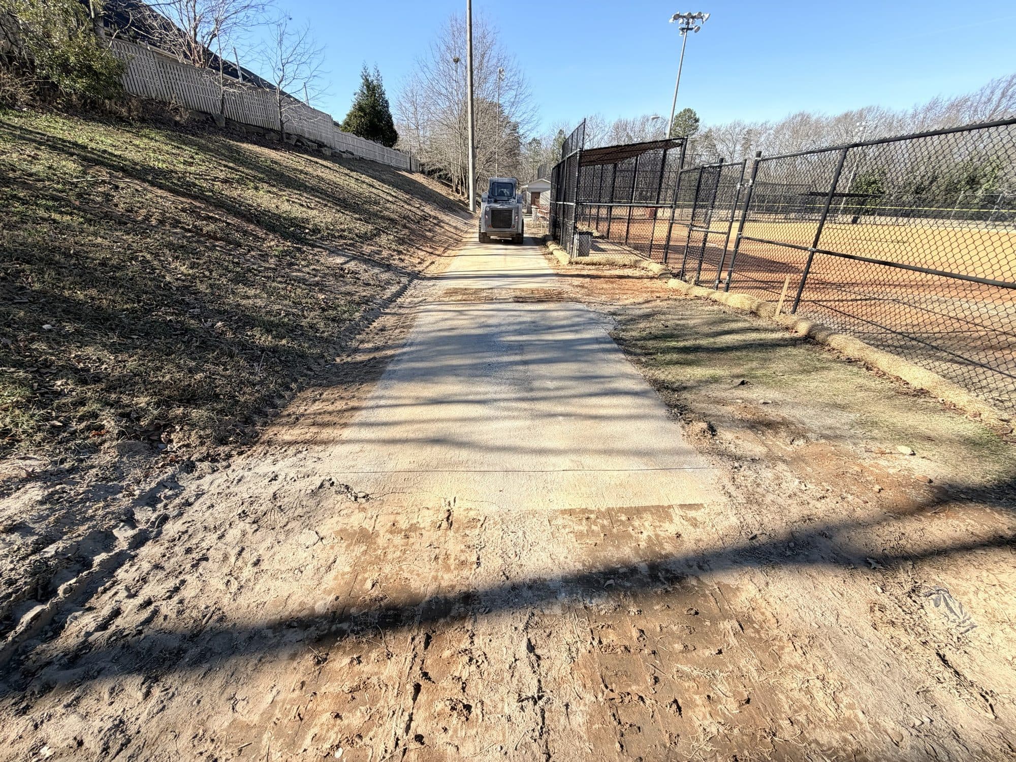 The new concrete drainage flume running up the slope between the ball fields at Butler Springs Park