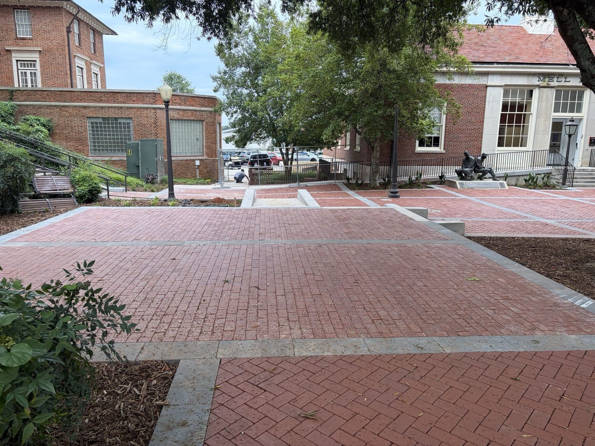 Wide view of the completed plaza with the Mell Hall buildings and Highway 93 beyond