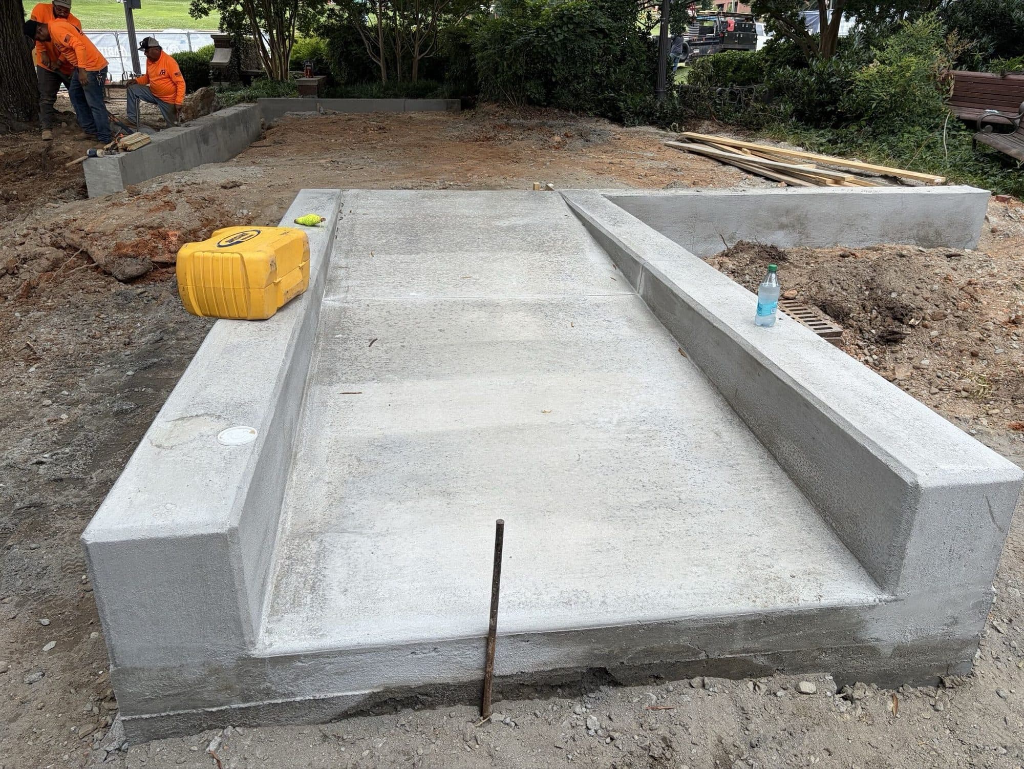 The concrete accessible ramp and landing formed and poured, with the plaza still at subgrade around it