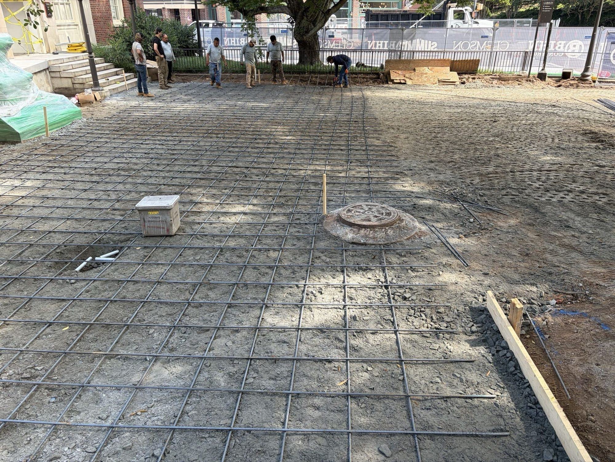 Reinforcing mesh laid across the prepared plaza base at Mell Hall before the concrete pour