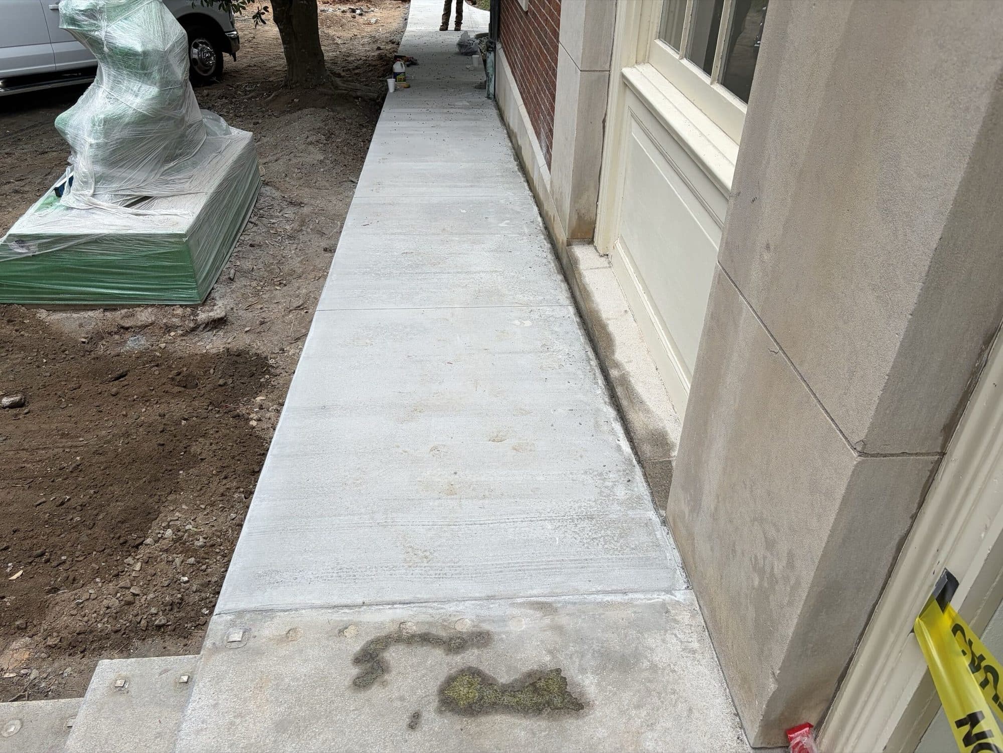 New concrete walk poured tight against the Mell Hall building line