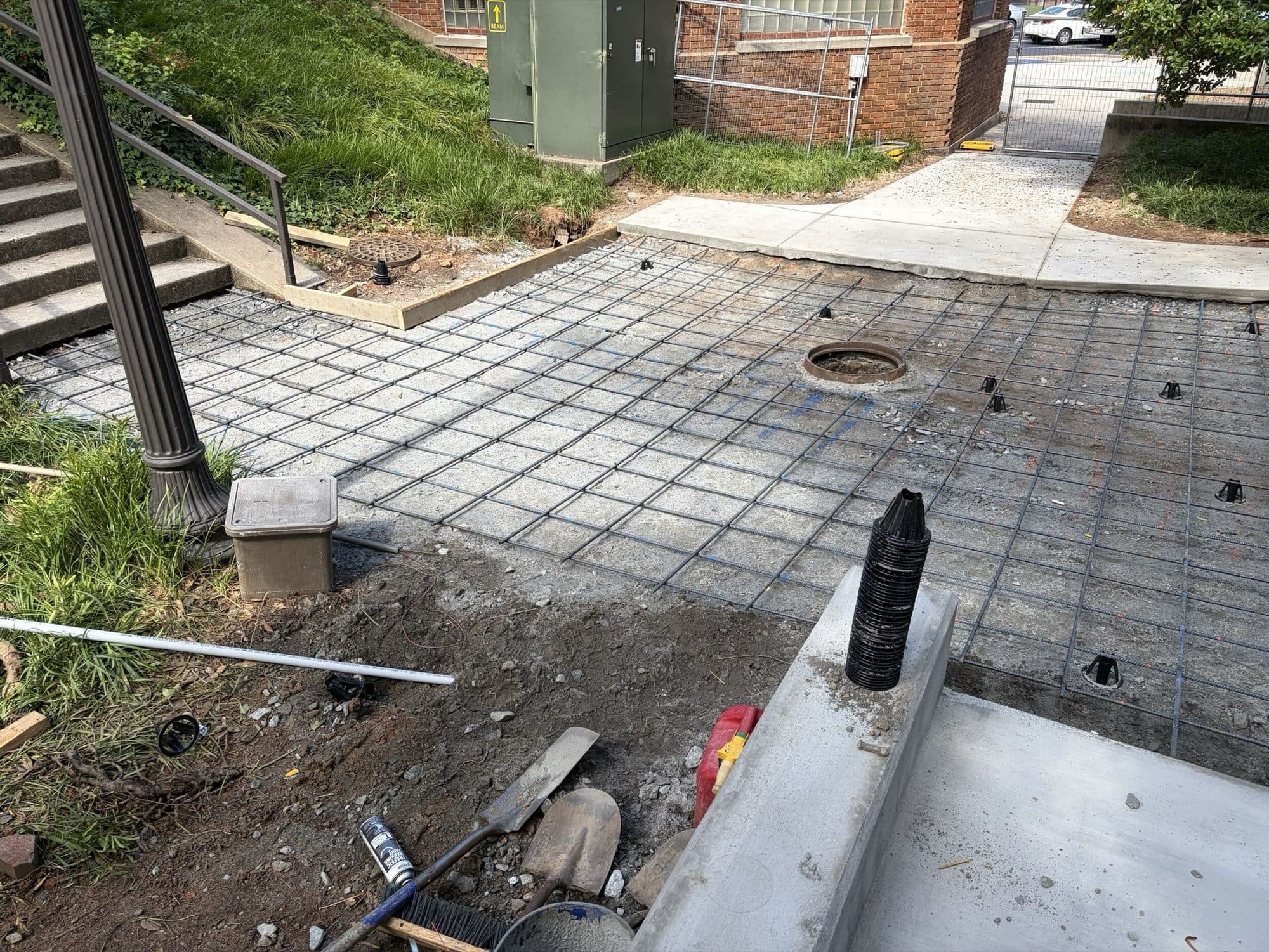 Reinforcing mesh and formed concrete curb at the stair and ramp approach to Mell Hall