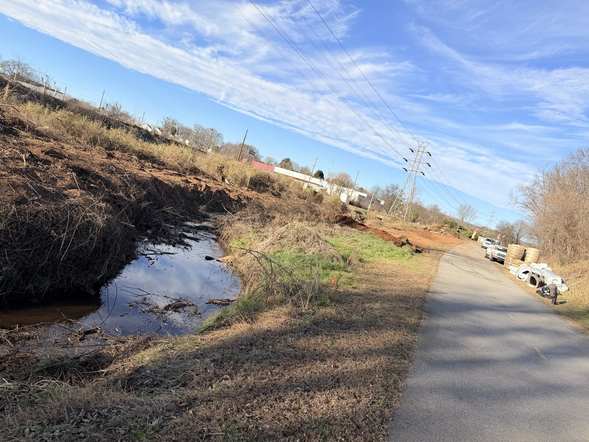 The new channel cut and holding water, with the greenway trail running alongside