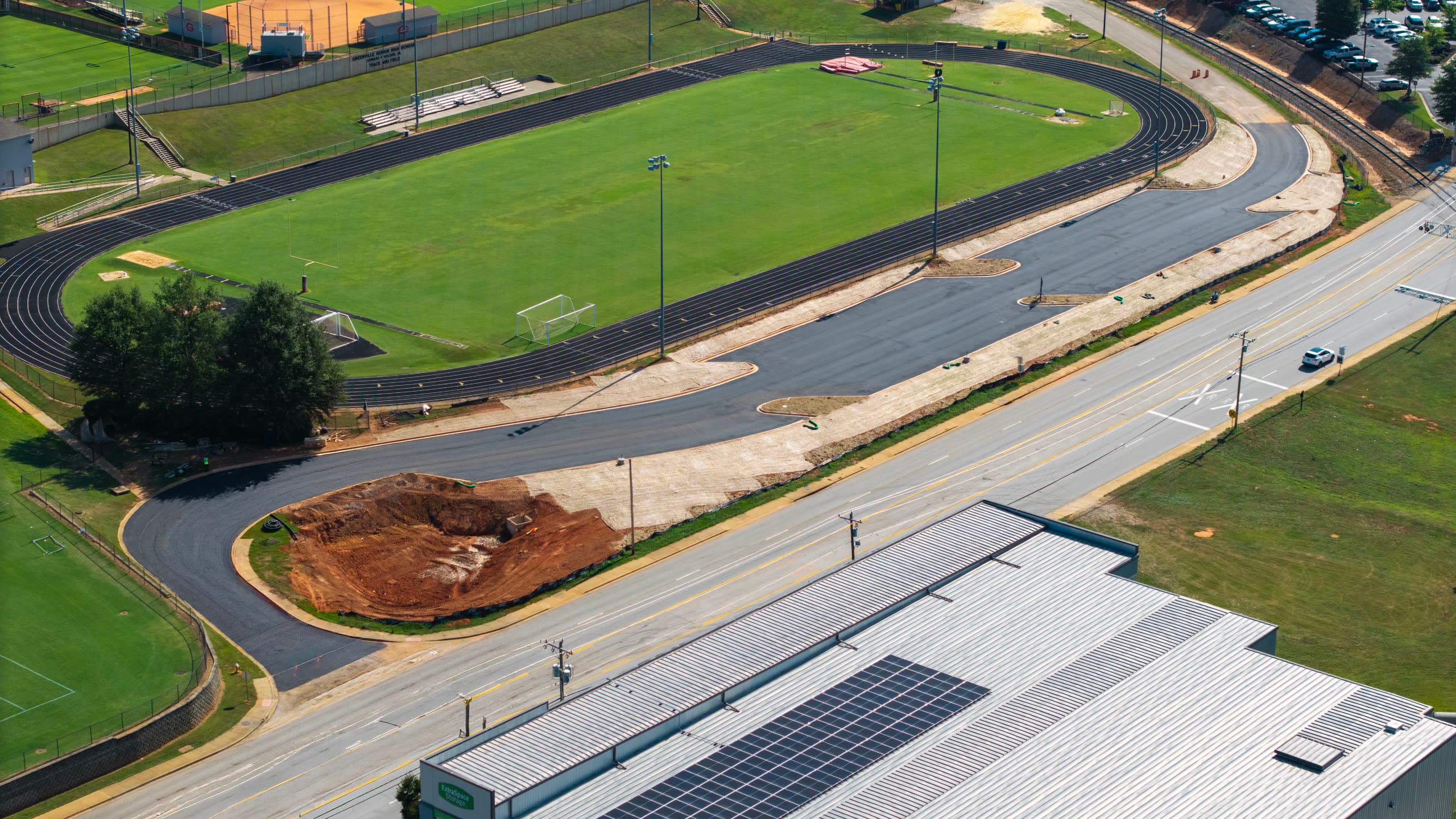 Looking back across the track toward the parking lot, with the landscape island still in raw grade