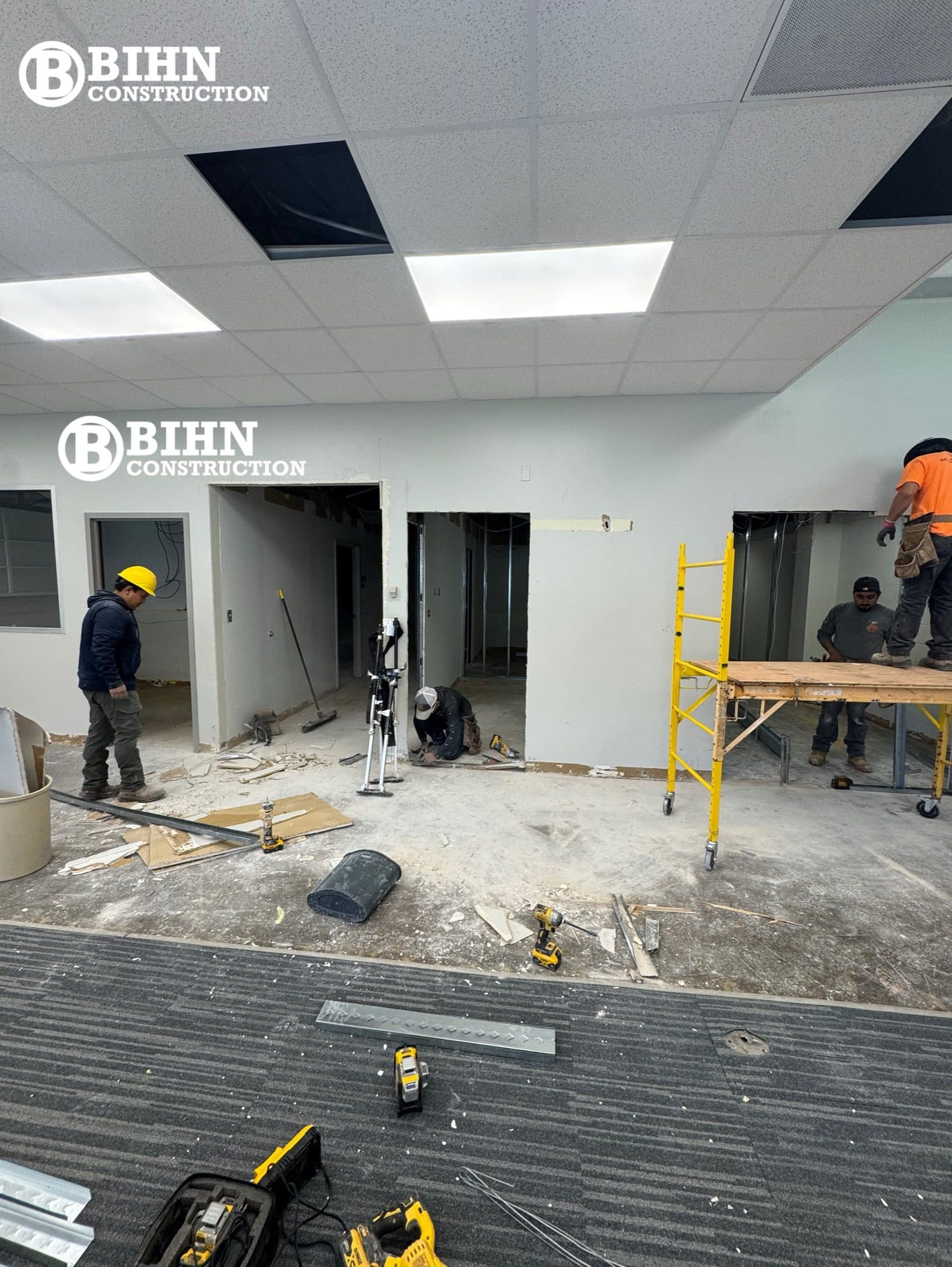 New ceiling grid and lighting going in over the renovated office area with MEP rough-in overhead