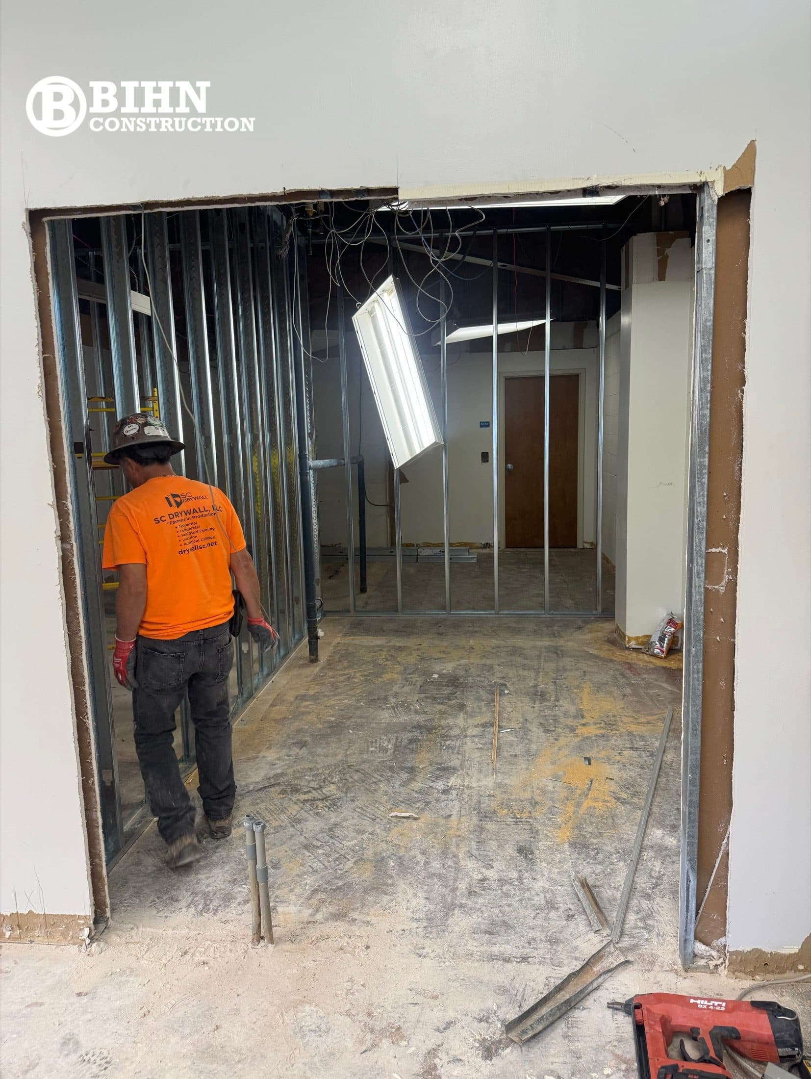 A worker framing a new opening in the demolished partition wall during the renovation