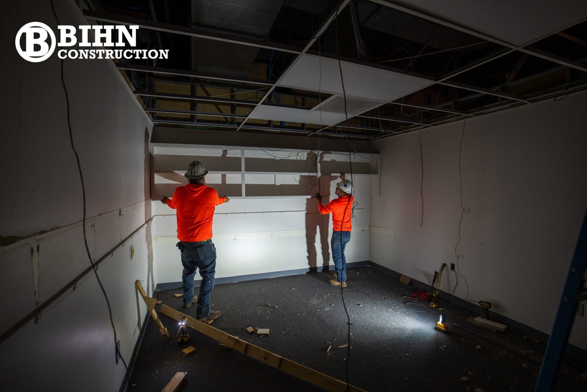 Crew hanging and finishing drywall on the new partitions