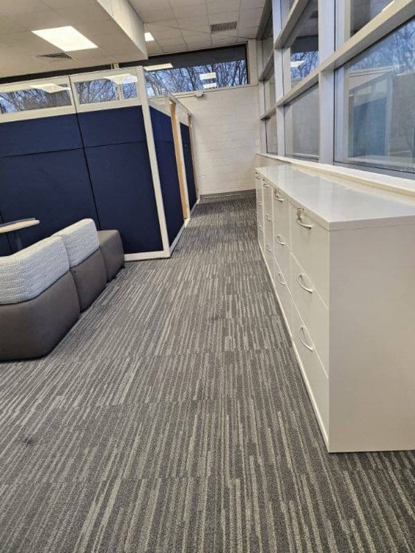 Finished workstations along the window wall with new casework and seating